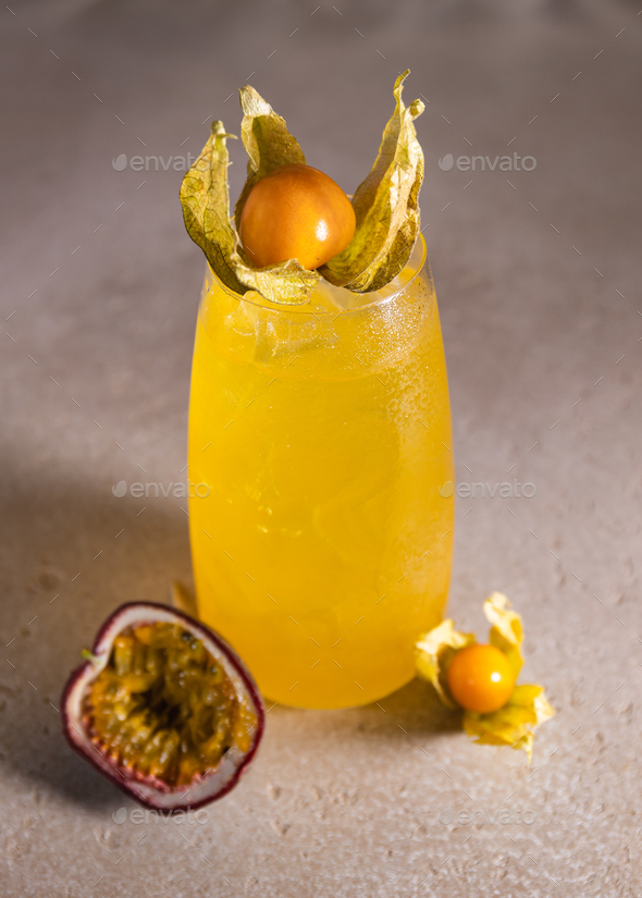 Physalis and passion fruit cold summer cocktail with ice. - Stock Photo - Images