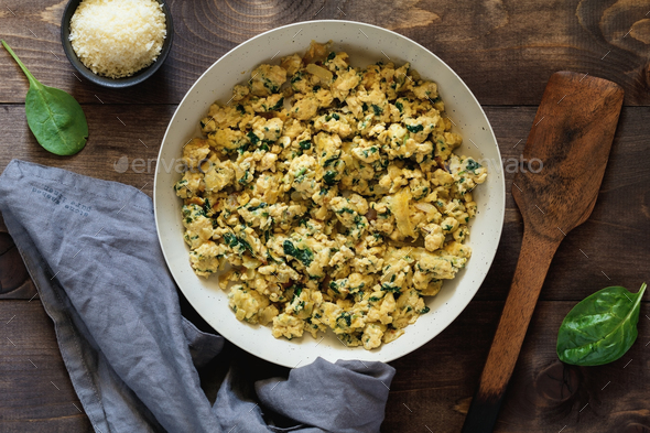 Scrambled eggs with spinach in a white pan - Stock Photo - Images