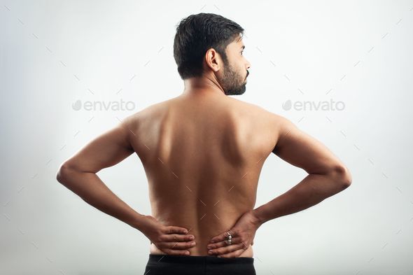 monochrome human body showing lower back injury pain on lumbar spine