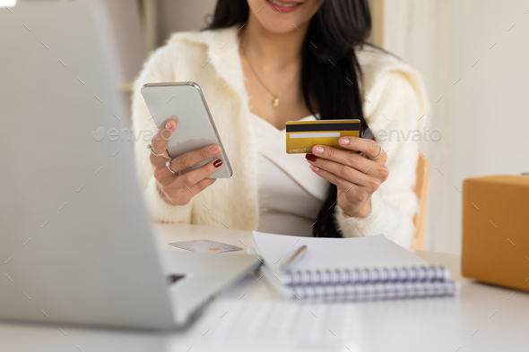 Concept of online money transactions through mobile phone and online shopping.