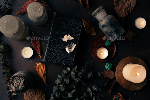Witchcraft still life concept with potion, spell book, herbs ingredients and magical equipment - Stock Photo - Images