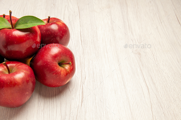 front view fresh red apples mellow and ripe fruits on a white desk fruit color fresh plant red tree