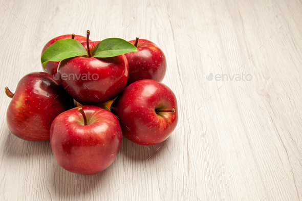 front view fresh red apples mellow and ripe fruits on light-white desk fruit color fresh plant red