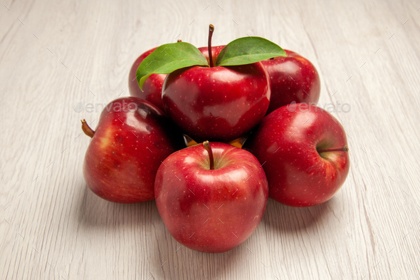 front view fresh red apples mellow and ripe fruits on white desk fruit color fresh plant red tree