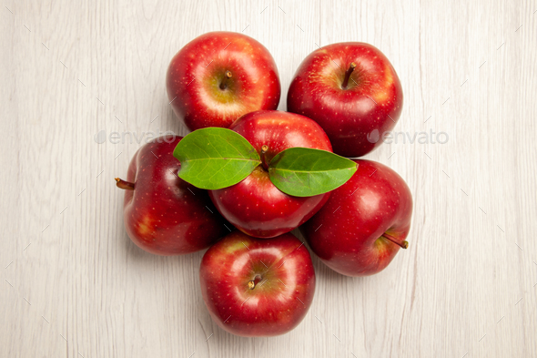 top view fresh red apples mellow and ripe fruits on a white desk fruit color fresh plant red tree