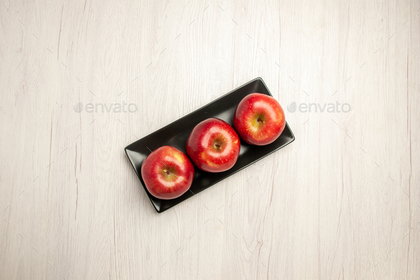 top view mellow red apples fresh fruits inside black pan on a white desk fruit mellow ripe fresh red