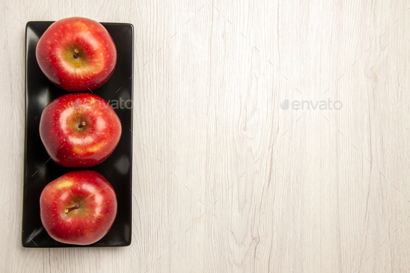 top view mellow red apples fresh fruits inside black pan on the white desk fruit mellow ripe fresh