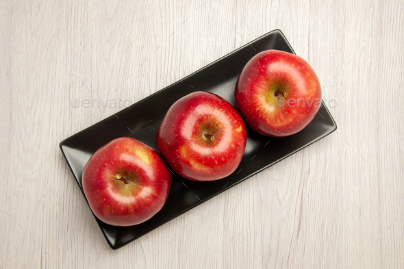 top view mellow red apples fresh fruits inside black pan on white desk fruit mellow ripe fresh red