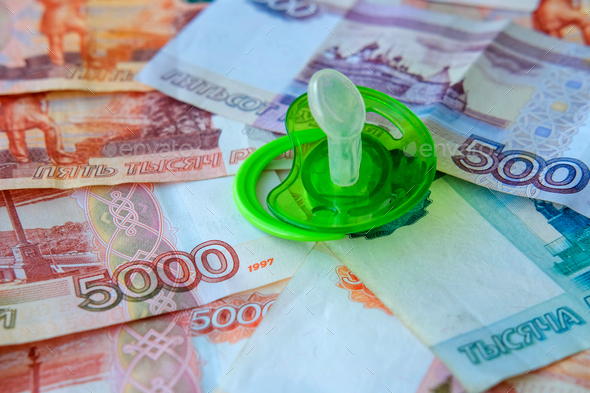 Green pacifier on Russian money five thousand, five hundred and one thousand rubles.