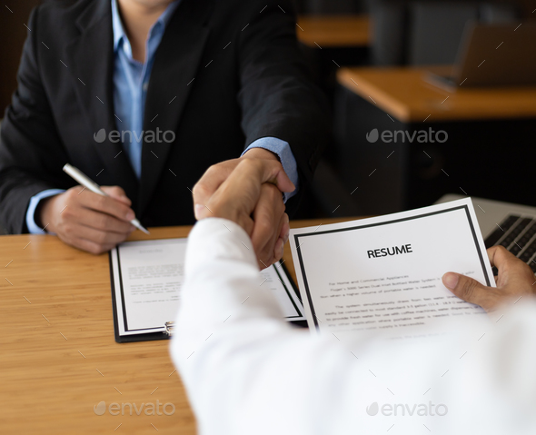 Good deal. Business, employer in office shaking hand of employee after successful job interview.