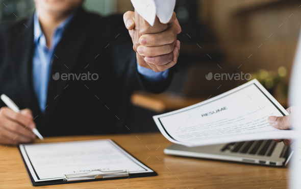 Good deal. Business, employer in office shaking hand of employee after successful job interview.