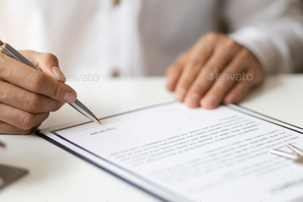 Businessman in casual clothes signing a real estate deal contract.