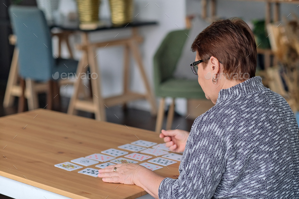 senior woman playing solitaire at home. Happy old lady plays an intellectual game - Stock Photo - Images