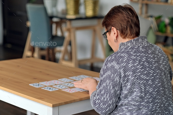 senior woman playing solitaire at home. Happy old lady plays an intellectual game - Stock Photo - Images