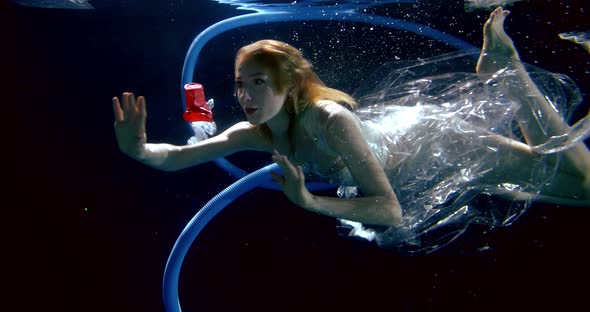Underwater Shooting of Woman Floating Between Plastic Waste, Concept of Pollution of World Oceans alt