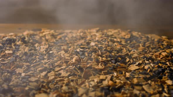Wooden Chips and Hot Charcoals with Light Steam in Smokery alt