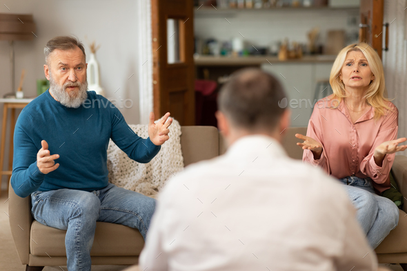 Unhappy Spouses Having Marital Therapy Session With Professional Psychologist Indoors
