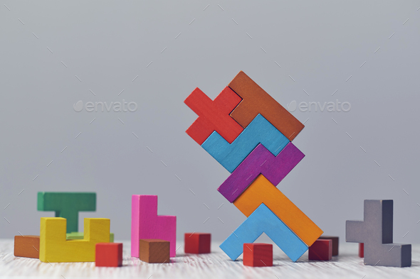 wooden block puzzle. wood cube stacking. Concept of complex and smart logical thinking.