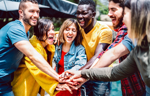 Young diverse friends stacking hands on positive union mood - Stock Photo - Images
