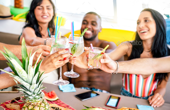 Trendy people toasting fancy cocktails at boat party trip - Stock Photo - Images