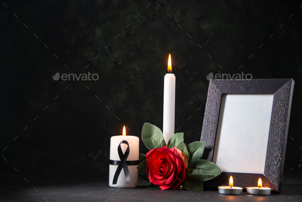 front view white candle with picture frame and flower on dark surface funeral evil death