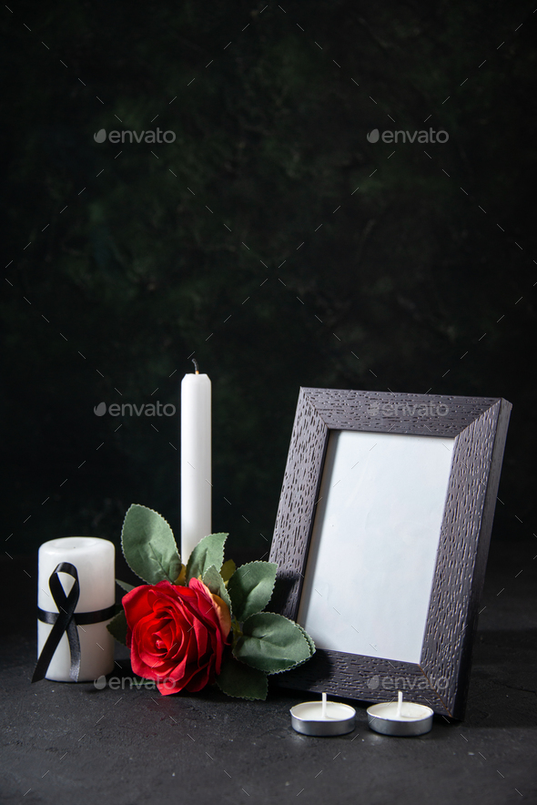 front view white candle with picture frame and flower on the dark background funeral evil death