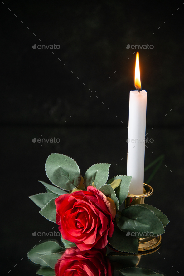 front view of burning candle with red flower on black background evil death  funeral war Stock Photo by AydinovKamran