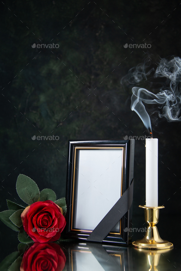 front view of fireless candle with picture frame on black background funeral evil war death