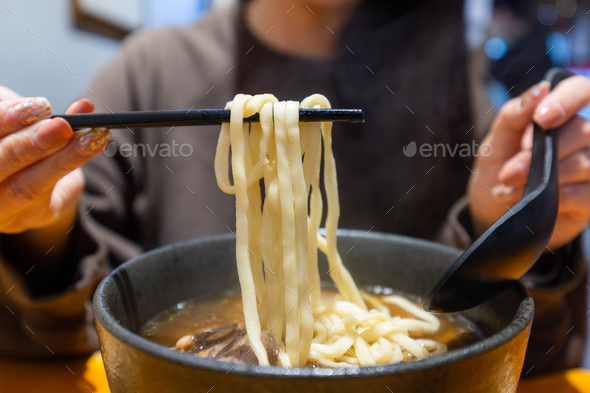 Woman eat Taiwan braised beef noodle soup - Stock Photo - Images