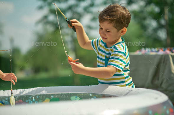 Happy Toddler Boy Playing In The Fishing. Hot Summer Day. Children ...