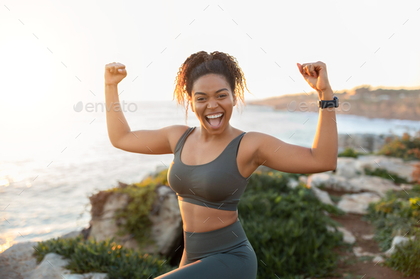 Slim athletic African American woman in sportswear doing exercises