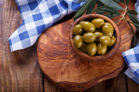 Green Mediterranean olives in a wooden bowl - Stock Photo - Images