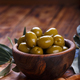 Green Mediterranean olives in a wooden bowl - PhotoDune Item for Sale