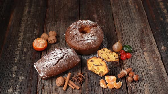 Christmas Composition of Dried Fruits and Stollen with Tangerine on a Wooden Textured Table with alt