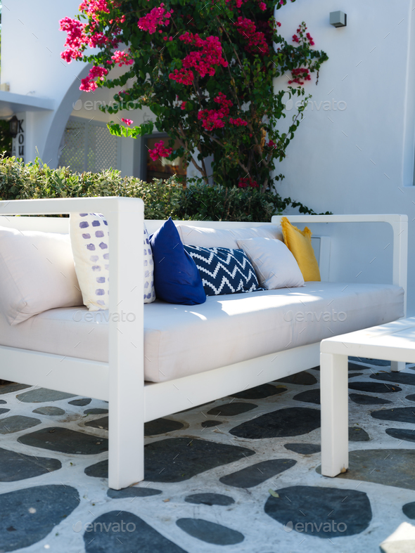 A cozy place to relax. Cushions on the couch in an outdoor cafe. Traditional Greek design.