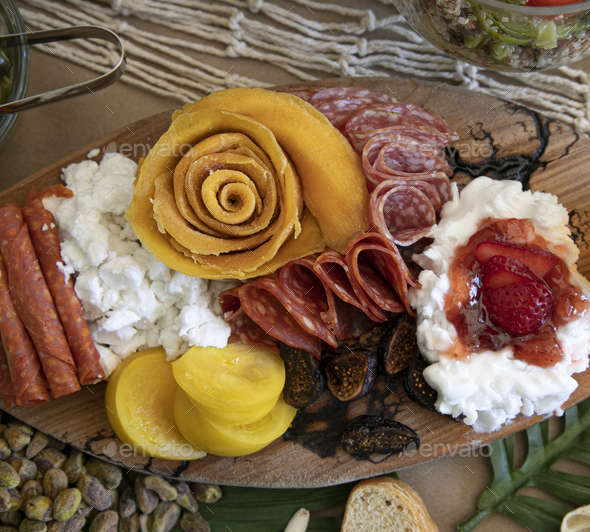 Detail shot of charcuterie table set up for lunch, with meats and cheeses in beautiful arrangement - Stock Photo - Images