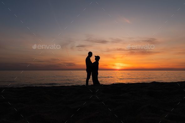 Download Couple At Beach Playful Pose Wallpaper | Wallpapers.com