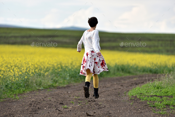 Young woman running on a countryside road. Freedom concept - Stock Photo - Images