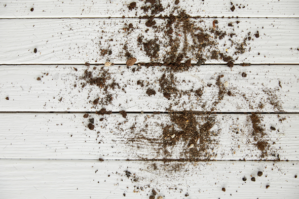 top view of dirt on white wooden table
