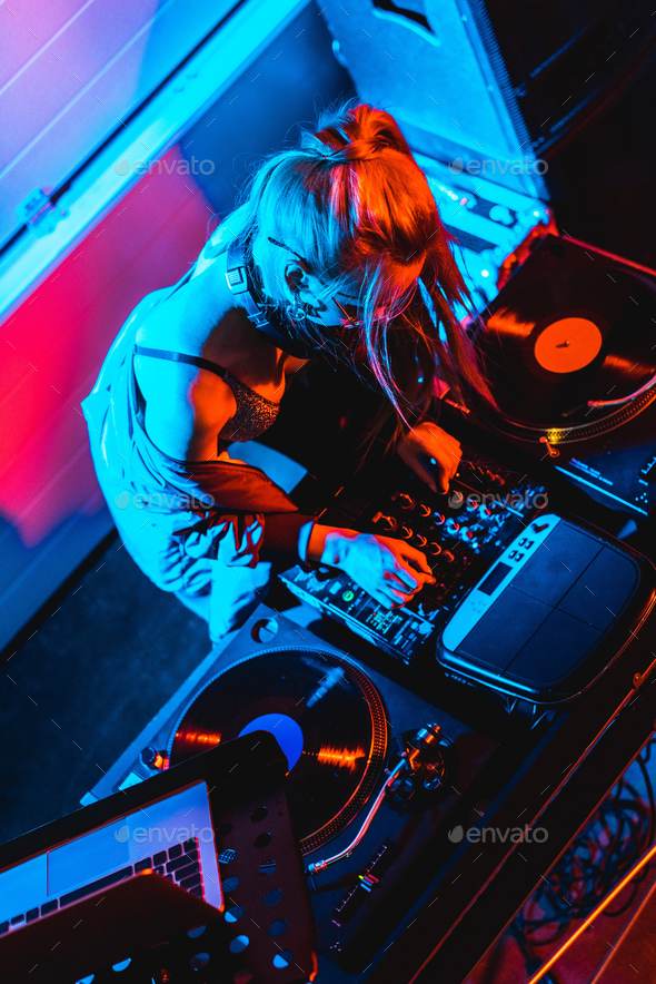 overhead view of blonde dj girl touching dj mixer in nightclub Stock ...