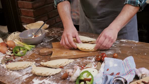 Man Cooking Empanadas Argetinian Pie Traditional Bakery From Argentina Chef Filling Dough in Home alt