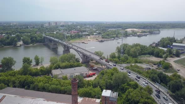 Aerial View of Car Traffic on Modern Bridge Over River in City in Summer Day