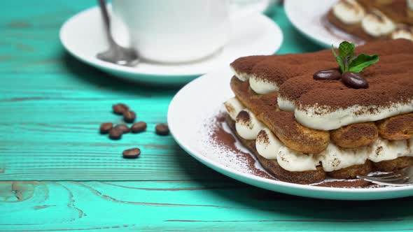 Two Portions of Classic Tiramisu Dessert, Cup of Coffee and Milk or Cream on Wooden Background alt