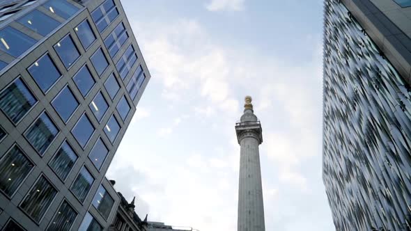 Monument On Background Of Business Buildings alt