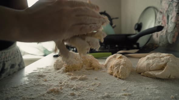 the Cook Sculpts Round Pieces of Dough in the Kitchen