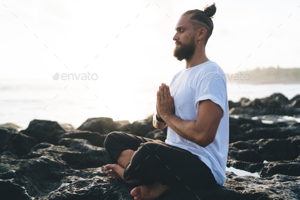 Young adult woman doing namaste pose - a Royalty Free Stock Photo from  Photocase