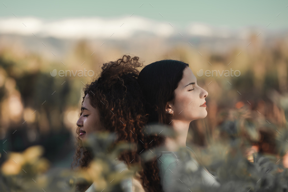 Women inhaling fresh air outdoors during sunrise