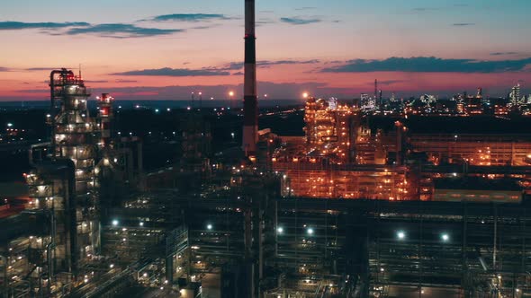 Premises of the Petroleum Refinery with Electric Lights at Sunset alt