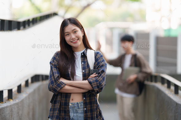 Young Asian woman college student with friends at outdoors. College student working on the college - Stock Photo - Images