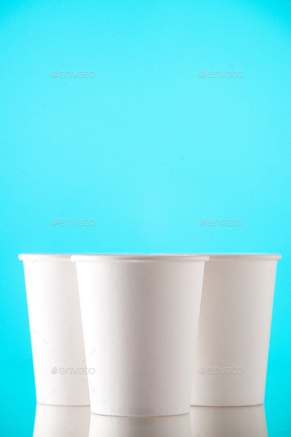 front view paper water cups on neon blue background Stock Photo by ...